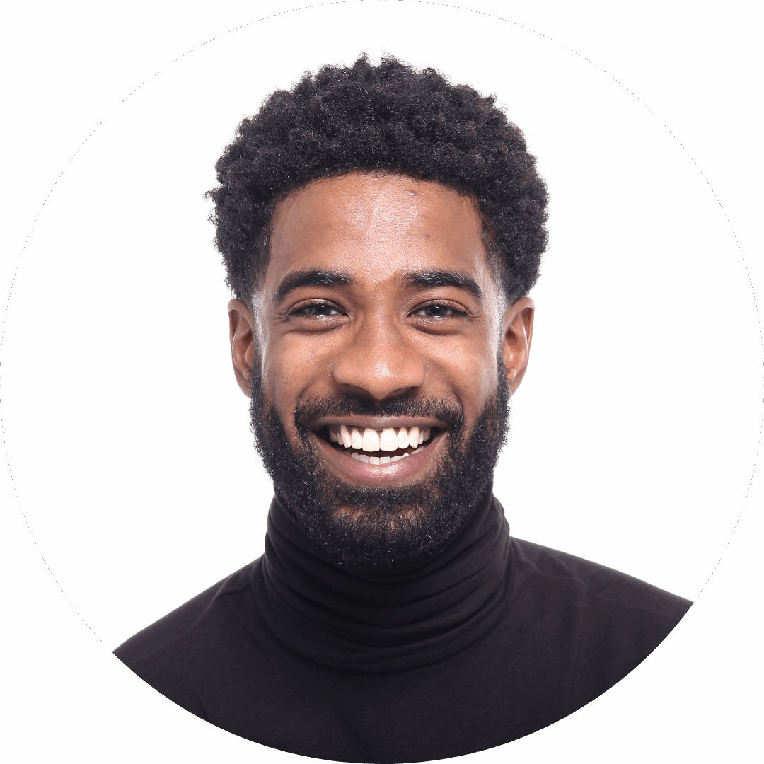 Smiling man with curly hair wearing a black turtleneck, exuding confidence and warmth