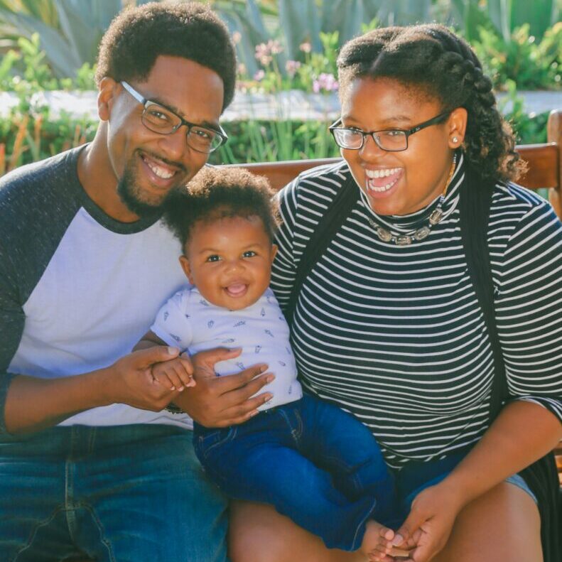 A family with a young child enjoying time together.
